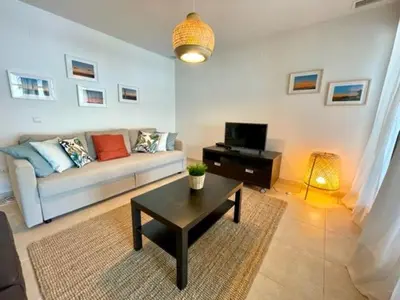 a living room with a couch and a coffee table at GATU PREMIUM Racimo, terraza, aire ac, piscina comun, wifi y parking 