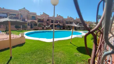 a bedroom with a bed with a floral bedspread at Al Andalus in Chiclana de la Frontera