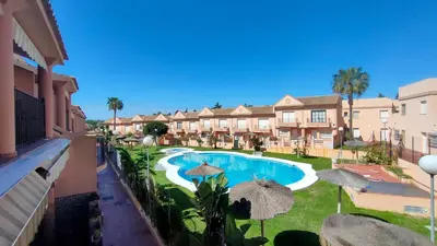 a patio with a table and chairs on a balcony at Al Andalus in Chiclana de la Frontera