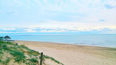 a sandy beach with a view of the ocean at Dunas y Luz in Rota