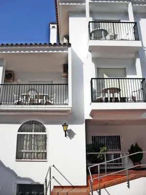 two balconies of a building with tables and chairs at Dunas y Luz in Rota