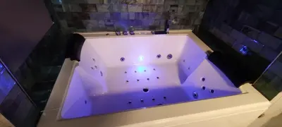 a bath tub with a purple lighting in a bathroom at Latorre jacuzzi jerez in Jerez de la Frontera