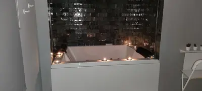 a bath tub with candles in a room at Latorre jacuzzi jerez in Jerez de la Frontera