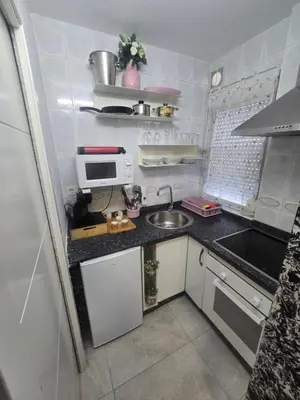 a small kitchen with a sink and a microwave at Latorre jacuzzi jerez in Jerez de la Frontera