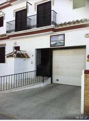 a garage with two garage doors in a building at Chipiona Apartamento Bajo Centro Parking Incluido WiFi GRATIS in Chipiona
