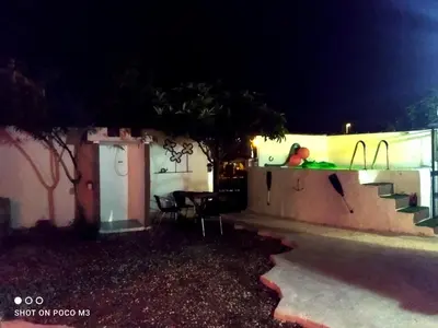 a patio at night with a table and chairs at Casa del abuelo antonioTrujillo in Conil de la Frontera