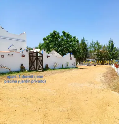 a dirt road in front of a white building at Casa del abuelo antonioTrujillo in Conil de la Frontera