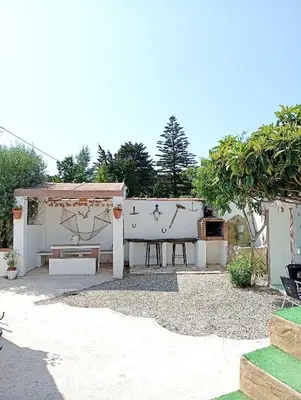 a backyard with a picnic table and a gazebo at Casa del abuelo antonioTrujillo in Conil de la Frontera