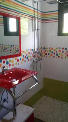 a bathroom with a red sink and a mirror at Casa Amelie in Hozanejos