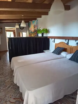 a group of three beds in a room at Casa Amelie in Hozanejos