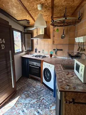 a kitchen with a washing machine on a counter at Casa Amelie in Hozanejos
