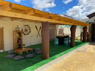 a patio with awning and a table and chairs at Casa Amelie in Hozanejos