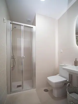 a bathroom with a shower and a toilet and a sink at Piso Torno in Sanlúcar de Barrameda