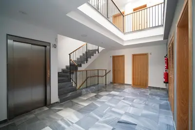 a hallway with a staircase and a skylight at Piso Torno in Sanlúcar de Barrameda