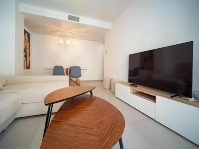 a living room with a large flat screen tv at Piso Torno in Sanlúcar de Barrameda