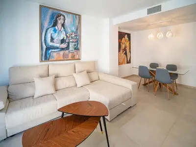 a living room with a couch and a table at Piso Torno in Sanlúcar de Barrameda