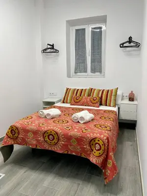 a bedroom with a bed with two towels on it at Anka Kurro in Rota
