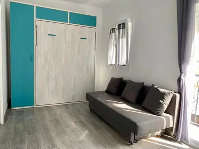 a living room with a couch and a sliding door at Anka Kurro in Rota
