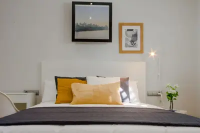 a bedroom with a bed with yellow pillows at La Casa del Mar in Chiclana de la Frontera
