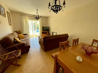 a living room with a couch and a table at Chalet Pura Vida in Chiclana de la Frontera