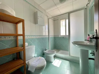 a bathroom with a toilet and a sink at Chalet Pura Vida in Chiclana de la Frontera