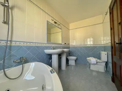 a bathroom with a tub and a sink and a toilet at Chalet Pura Vida in Chiclana de la Frontera