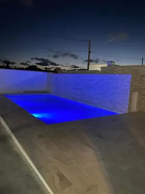 a pool with blue lighting on a roof at night at Erika & Julia in Chiclana de la Frontera