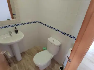 a bathroom with a toilet and a sink at Villa Libertad in Conil de la Frontera