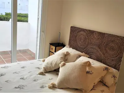 a bedroom with a bed with pillows on it at Villa Libertad in Conil de la Frontera