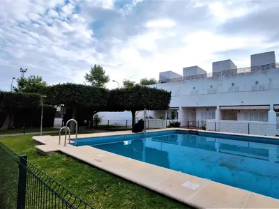 a swimming pool in front of a building at Villa Libertad in Conil de la Frontera