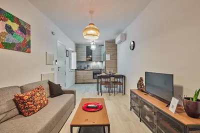 a living room with a couch and a tv at Redo Home in Cádiz
