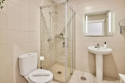 a bathroom with a shower and a toilet and a sink at Redo Home in Cádiz