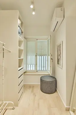 a room with a round stool in front of a window at Redo Home in Cádiz