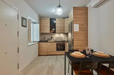 a kitchen with a table and a dining room at Redo Home in Cádiz
