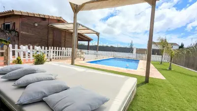 a bed with pillows on it in a yard at Conil, 5min centro, playas in Conil de la Frontera