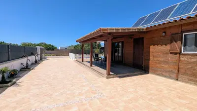 a patio with a house with solar panels on it at Conil, 5min centro, playas in Conil de la Frontera