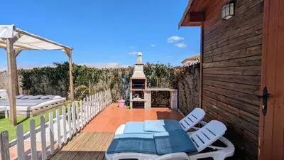 a patio with a table and chairs on a deck at Conil, 5min centro, playas in Conil de la Frontera