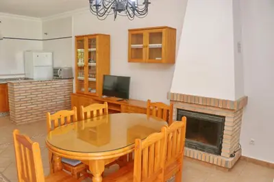 a dining room with a table and a fireplace at Chalet La Florida in Conil de la Frontera