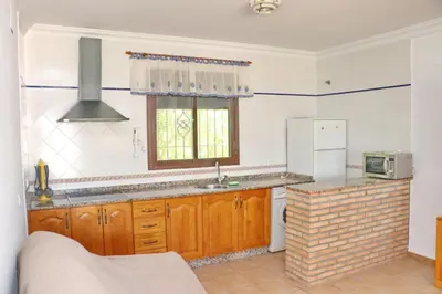 a kitchen with a sink and a refrigerator at Chalet La Florida in Conil de la Frontera