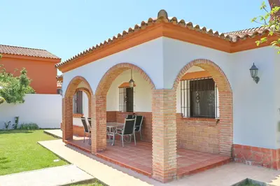 a patio with arches on a house at Chalet La Florida in Conil de la Frontera
