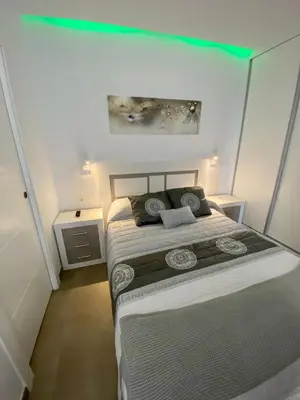 a bedroom with a bed and two night stands at Loft Deluxe Raquel in Conil de la Frontera