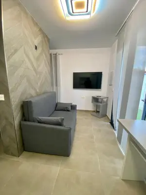 a living room with a couch and a flat screen tv at Loft Deluxe Raquel in Conil de la Frontera