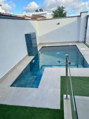 a swimming pool on the side of a house at Loft Deluxe Raquel in Conil de la Frontera