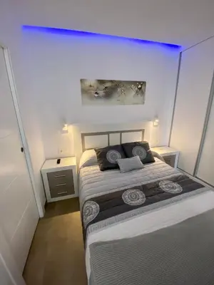 a bedroom with a large bed with two night stands at Loft Deluxe Raquel in Conil de la Frontera
