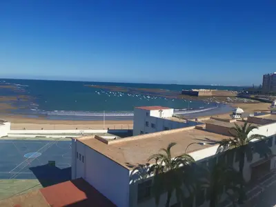 a view of the beach from the roof of a building at Apartamento en la Caleta in Cádiz