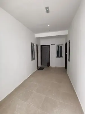 an empty hallway with white walls and a tile floor at Apartamento en la Caleta in Cádiz