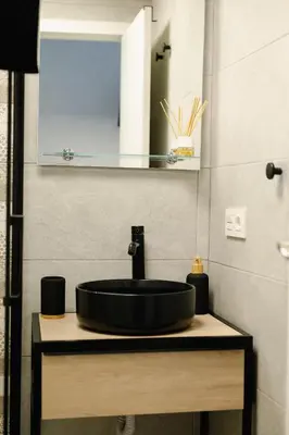 a bathroom with a black sink and a mirror at El Tablao in Jerez de la Frontera