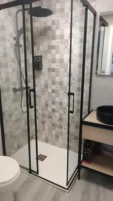 a bathroom with a glass shower with a toilet at El Tablao in Jerez de la Frontera