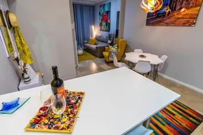 a bottle of wine on a table in a living room at SH Lupe Caleta Beach. A 100 m de playa in Cádiz