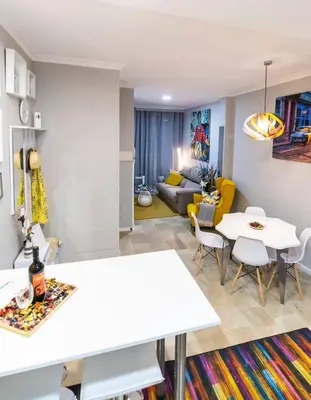 a living room with a table and a couch at SH Lupe Caleta Beach. A 100 m de playa in Cádiz